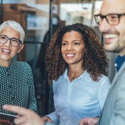 group of racially and gender diverse office workers smiling